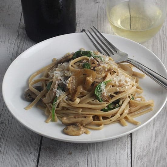 spinach and mushroom pasta served with white wine.
