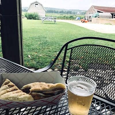 cuban sandwich with a glass of sparking wine on patio at Westport Rivers Vineyard.