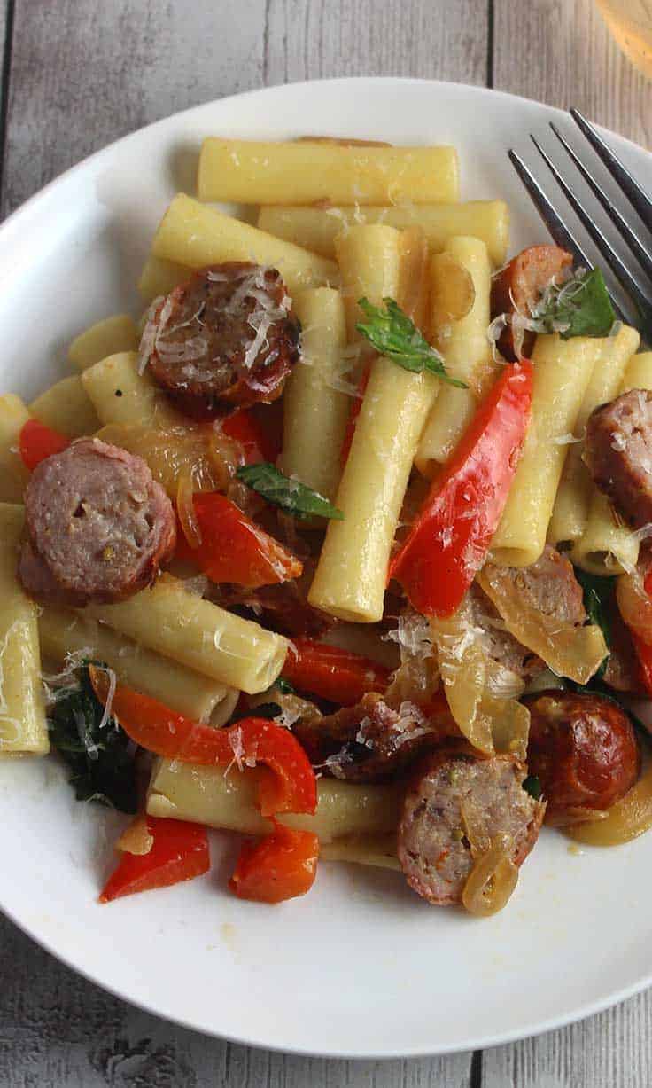 plate with pasta, sausages and peppers