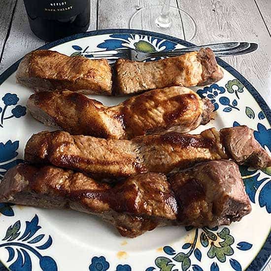 boneless baked pork ribs on a plate.