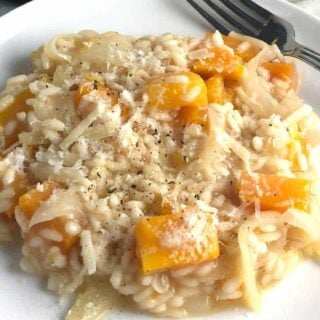 butternut squash risotto on a white plate.