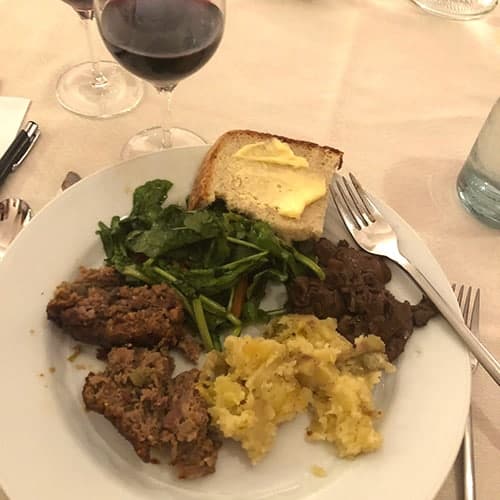 sautéed porcini on a plate with meatloaf and potatoes.