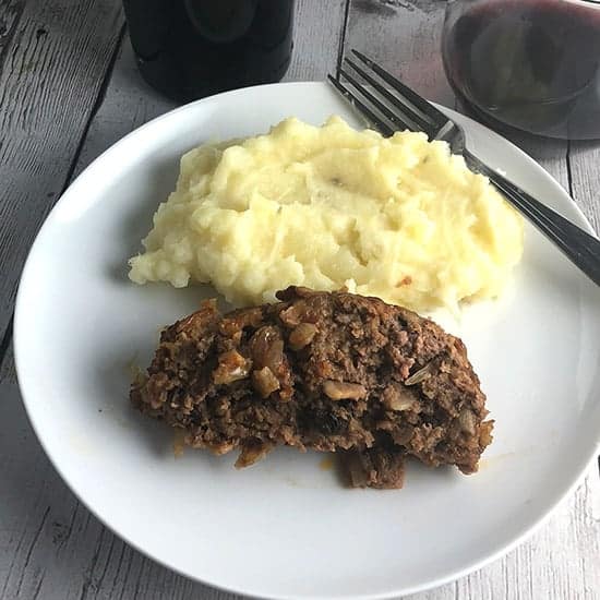 quick meatloaf on a plate with mashed potatoes.