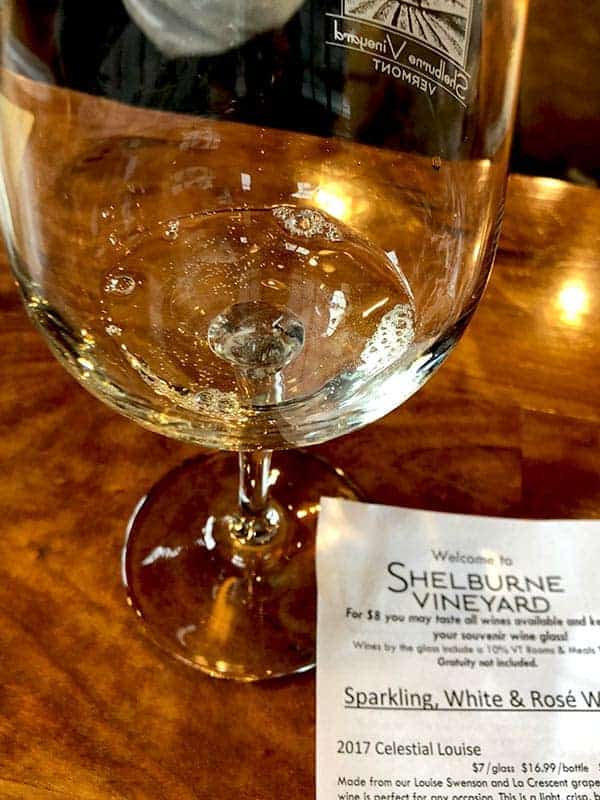 glass of wine and tasting sheet at Shelburne Vineyard.