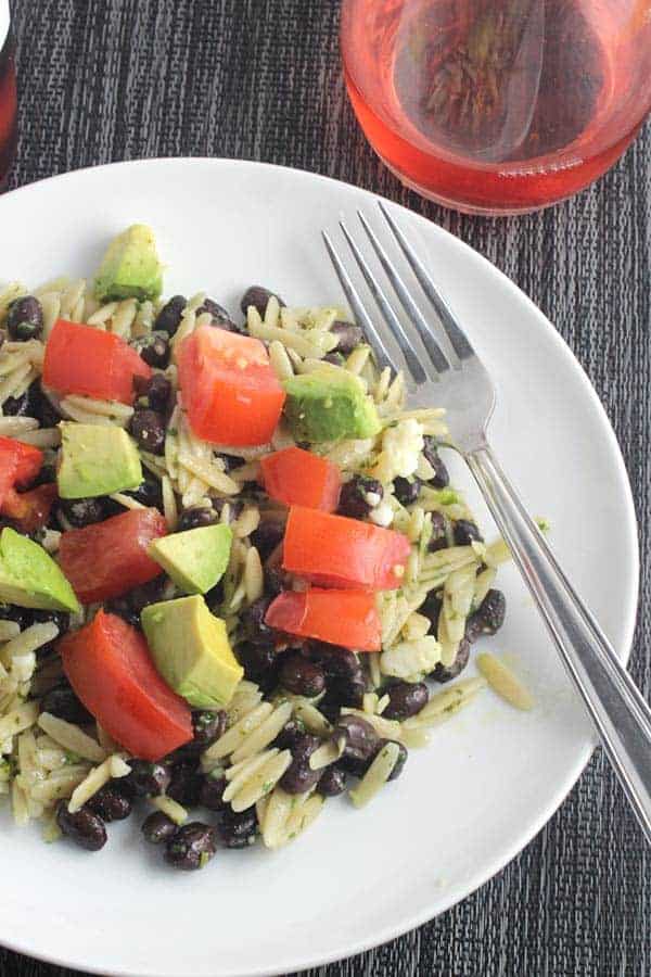 Orzo tossed with zesty cilantro pesto and black beans, topped with tomatoes and avocado. #cilantro #pesto #orzo