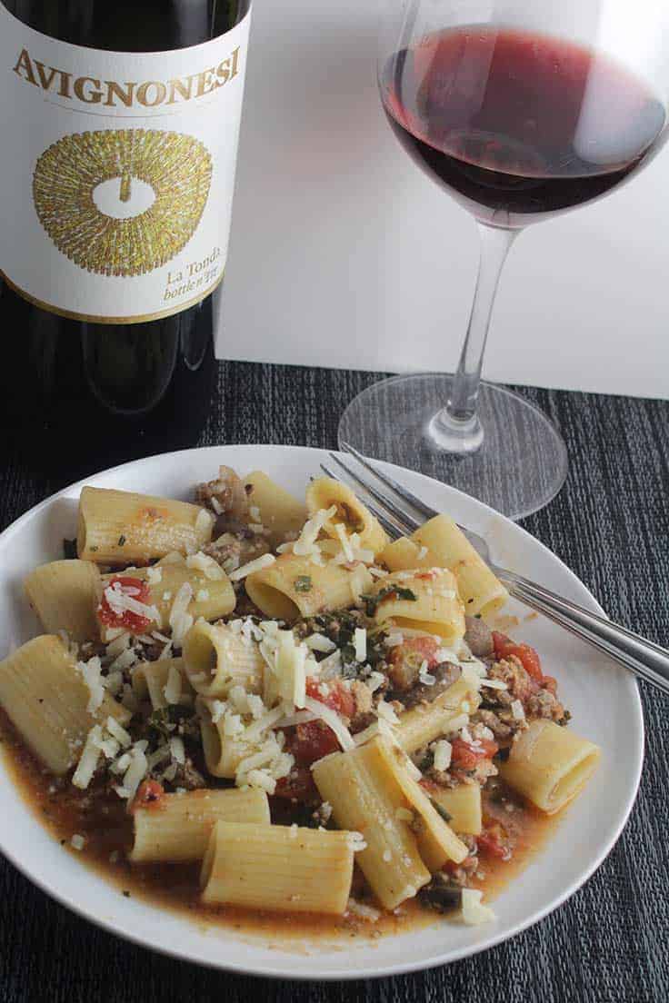 plate of healthy bolognese with sauce and red wine.