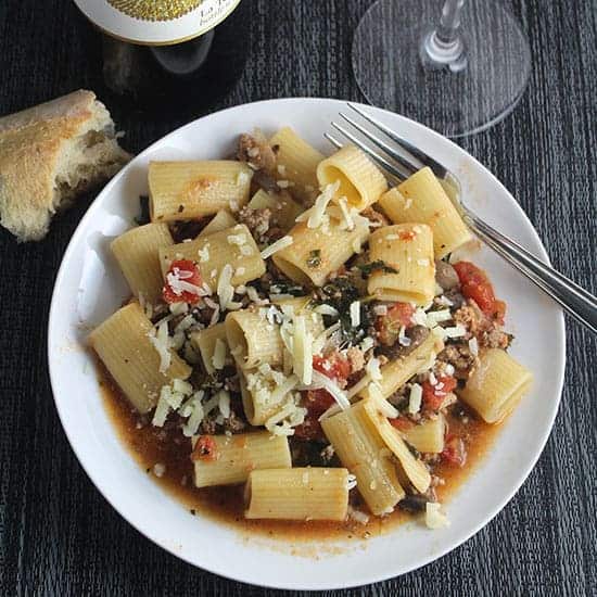 healthy Bolognese sauce served with rigatoni and bread on the side.