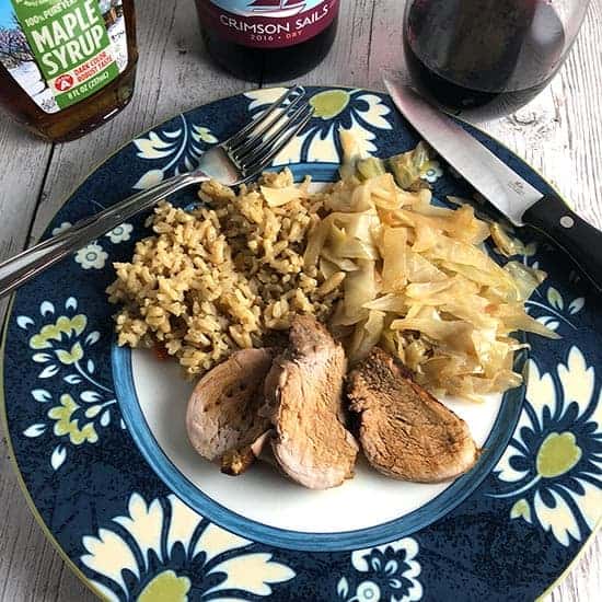 Maple Pork Tenderloin plated with rice and cabbage.