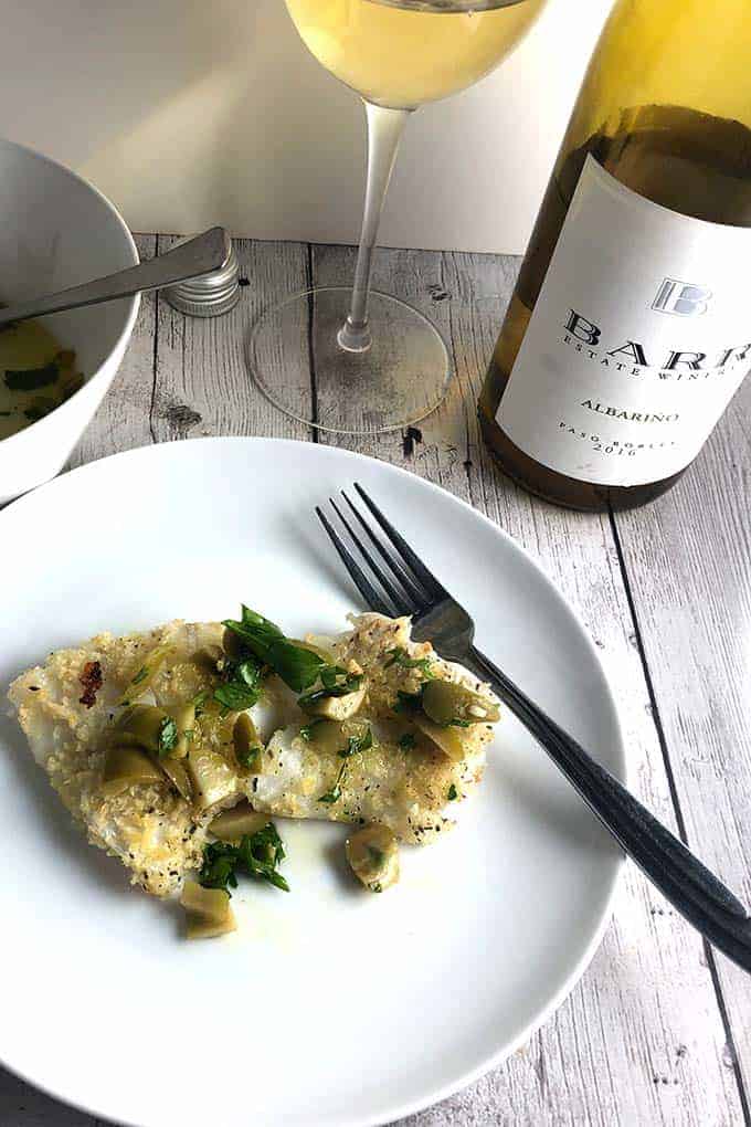 easy baked cod plated and served along with Albariño wine. 