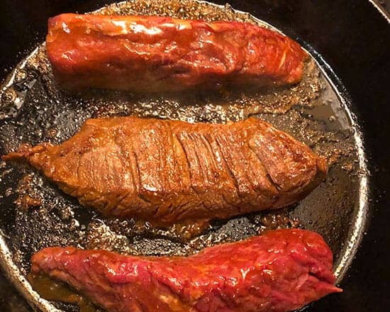 browning steak tips in skillet