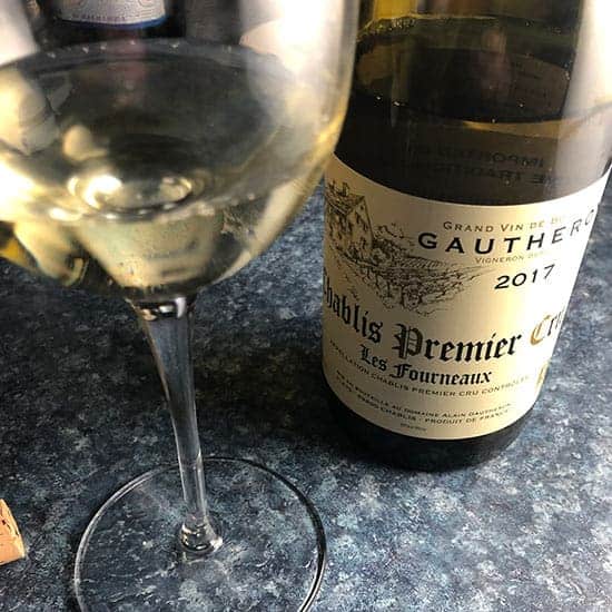 bottle of Les Fournaux Chablis with a glass poured.