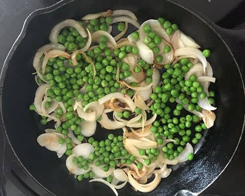 peas and onions in a skillet.