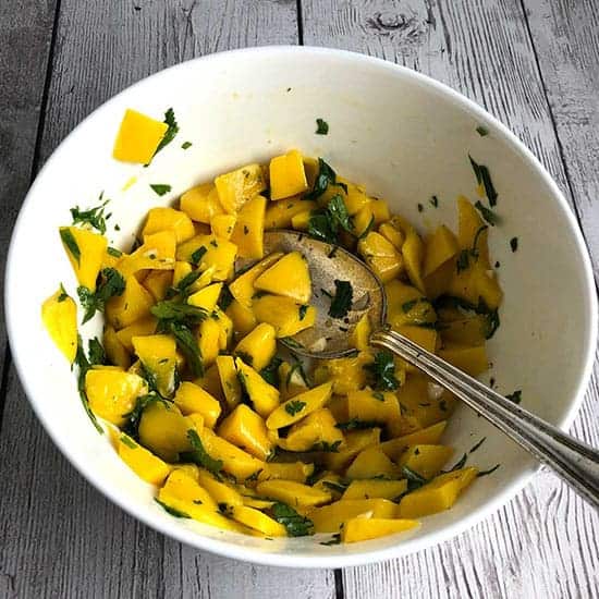 mango salsa in a white bowl.