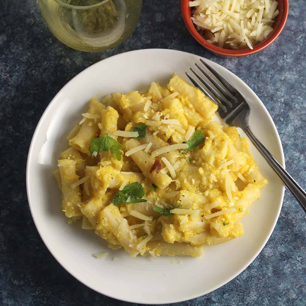 creamy roasted acorn squash pasta served on a white plate