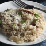 mushroom truffle risotto on a white plate.
