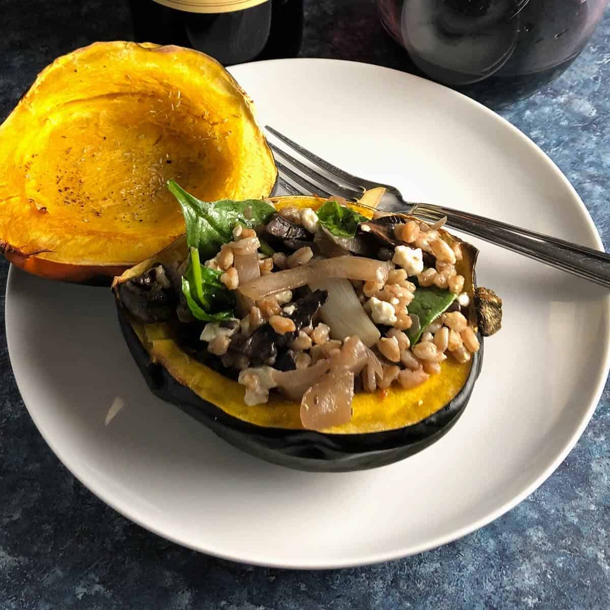 vegetarian stuffed acorn squash, one half filled 