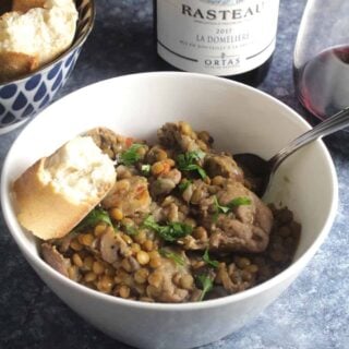 bowl of chicken and lentil stew with red wine.