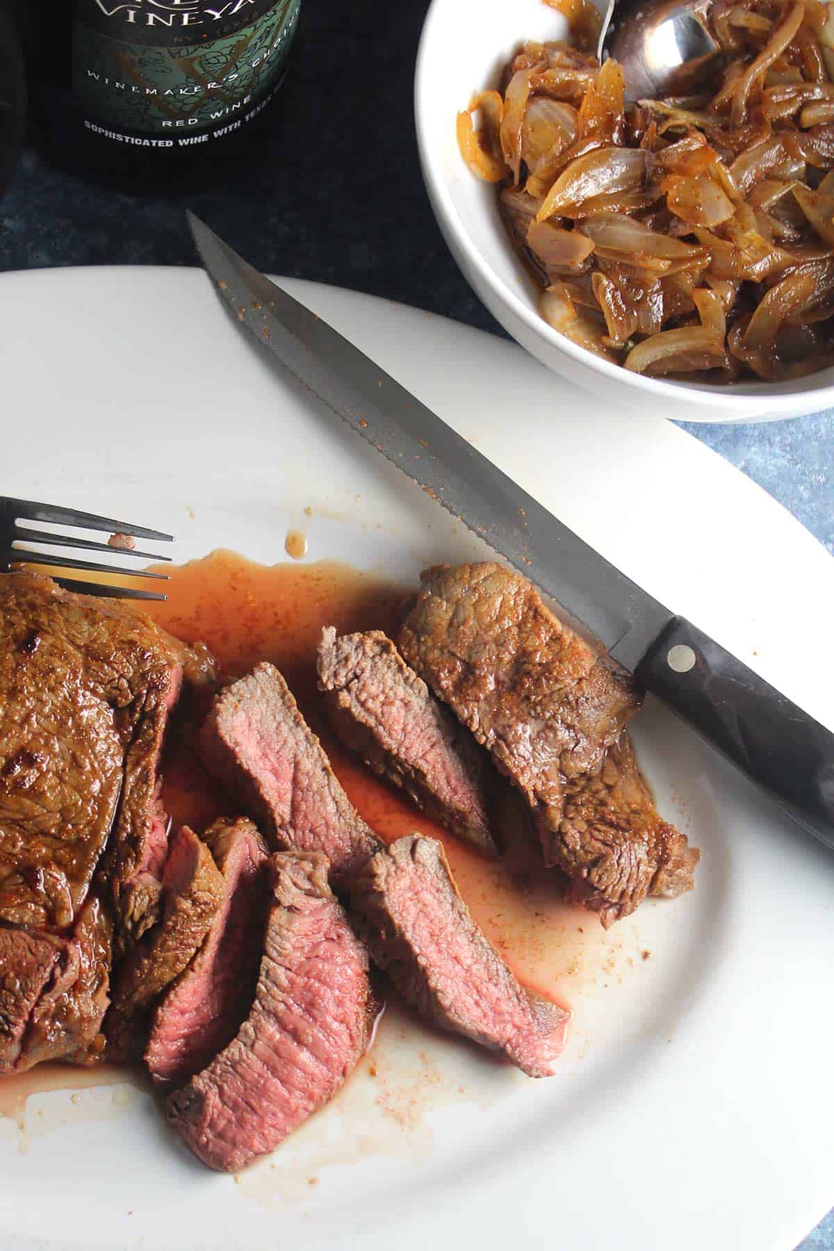 roasted sirloin steak sliced on a platter.