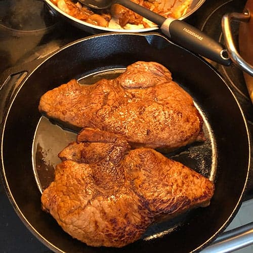 cooking sirloin steak in a skillet