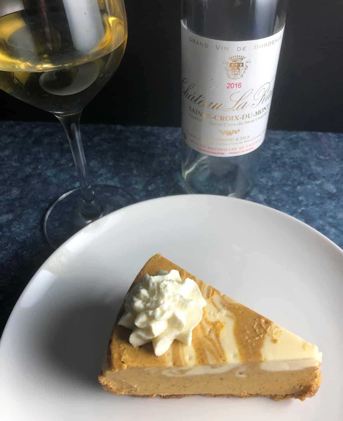 slice of pumpkin cheesecake served with a Sweet Bordeaux.