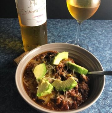 bowl of turkey chili paired with sweet bordeaux wine.