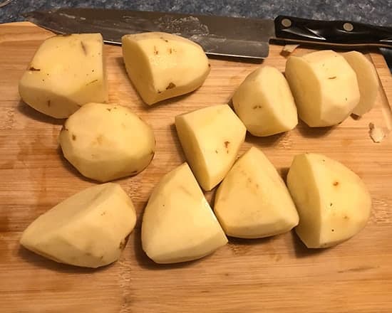 chopping potatoes on cutting board