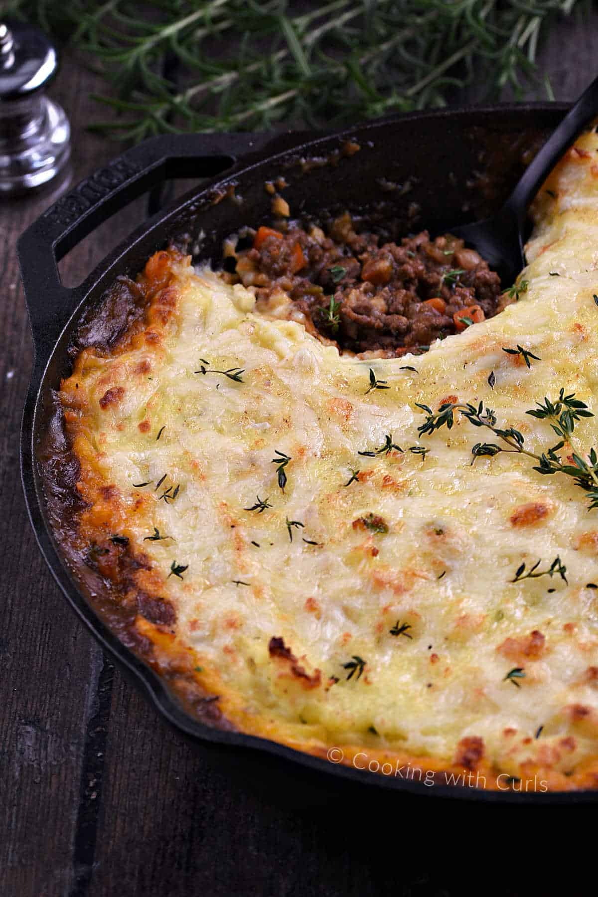 a cottage pie, with ground beef filling topped with potatoes and cheese.