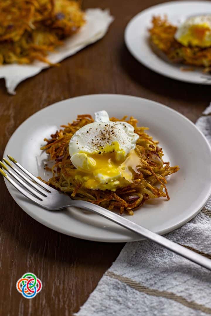 a poached egg served on a shredded potato cake.