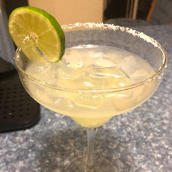 margarita in glass with salt and lime on rim