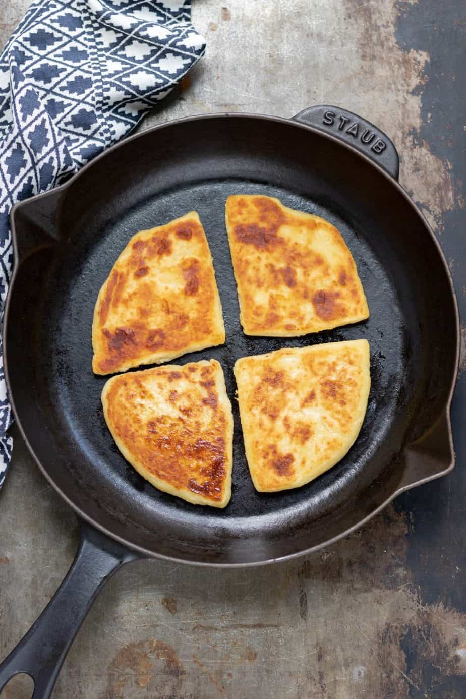 Veggie farls, an Irish name for potato cakes, shown in a black skillet.