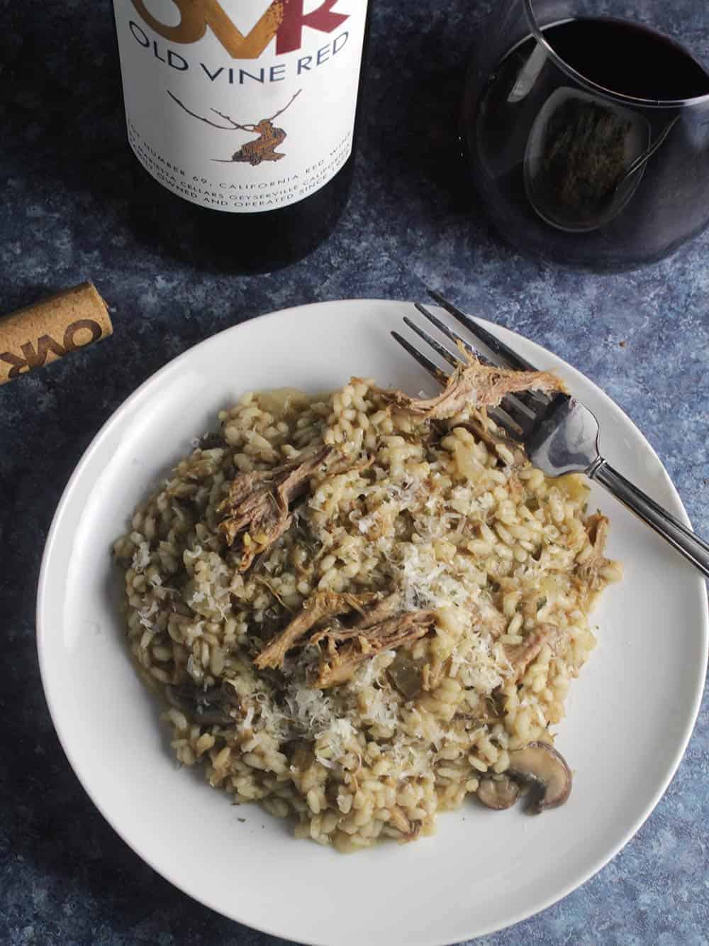 plate of pulled pork risotto with red wine.