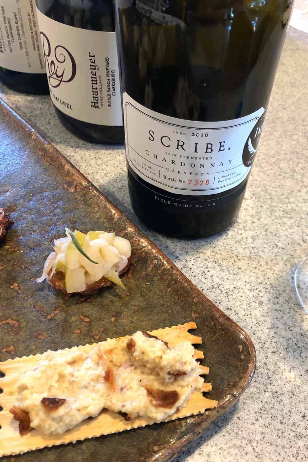 bottle of Scribe wine with appetizers