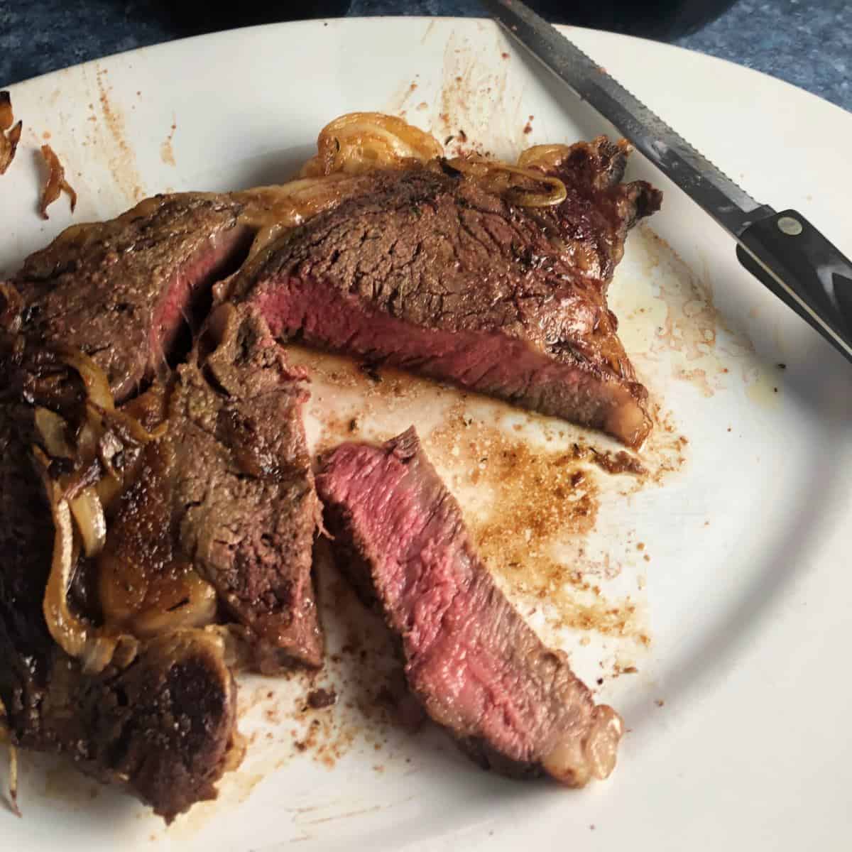 Wagyu ribeye on a white cutting board