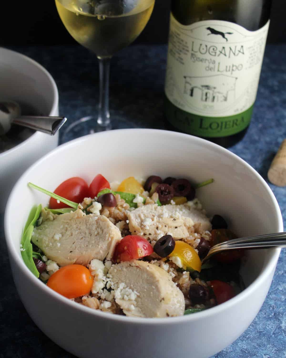bowl of Mediterranean Chicken Salad with white wine.