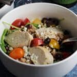 Mediterranean chicken salad in a white bowl.