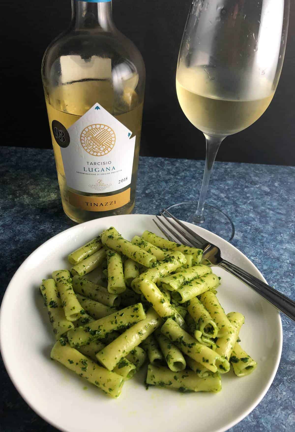 plate of kale pesto past with white wine.