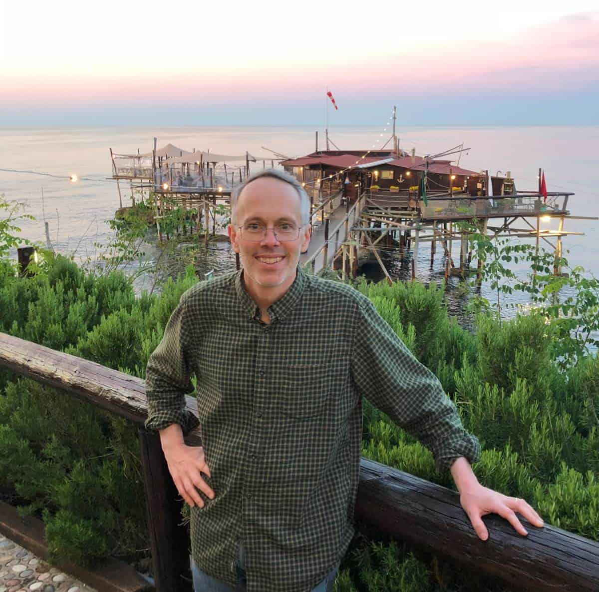 outside a trabucco restaurant in Abruzzo at sunset.