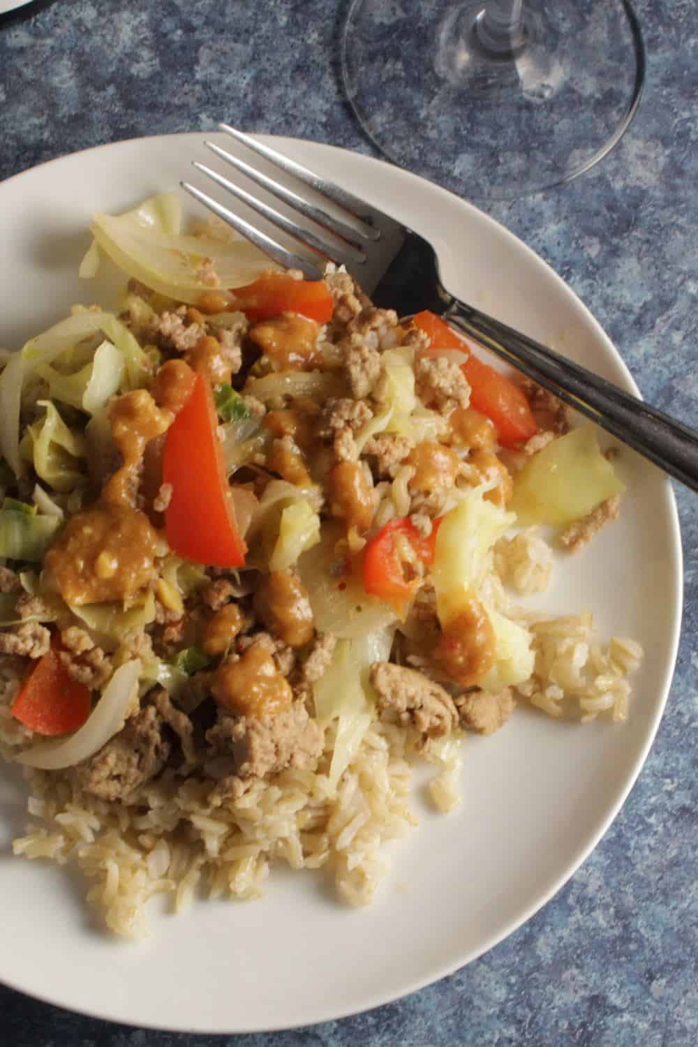 white plate with a healthy ground turkey stir-fry.