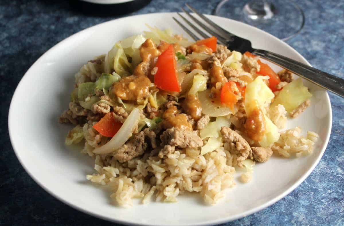 turkey and cabbage stir-fry on a white plate.