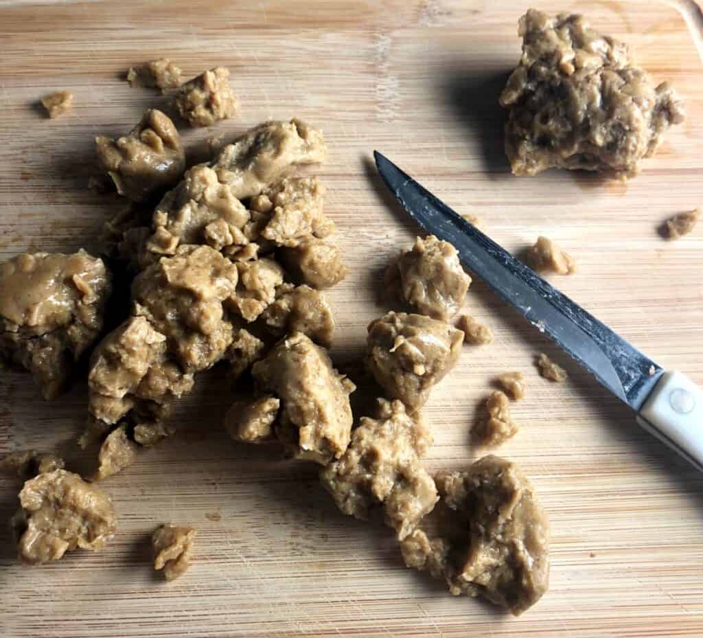 slicing seitan on a cutting board.