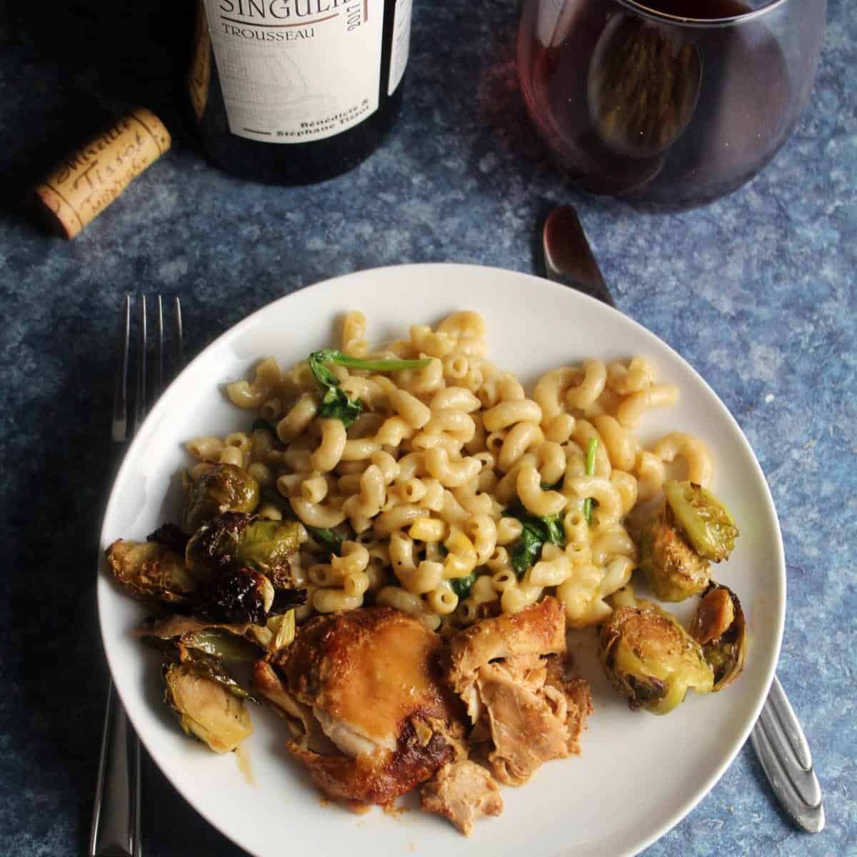 slow cooker BBQ chicken thights served with baked pasta, Brussels sprouts and red wine.