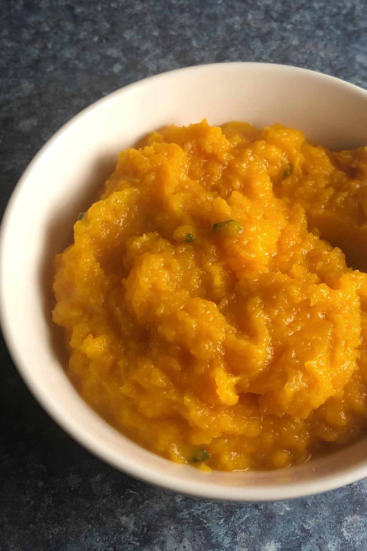 white bowl with mashed butternut squash.