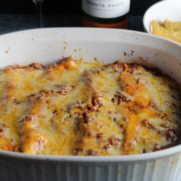 ground turkey enchiladas in a baking dish topped with melted cheese.