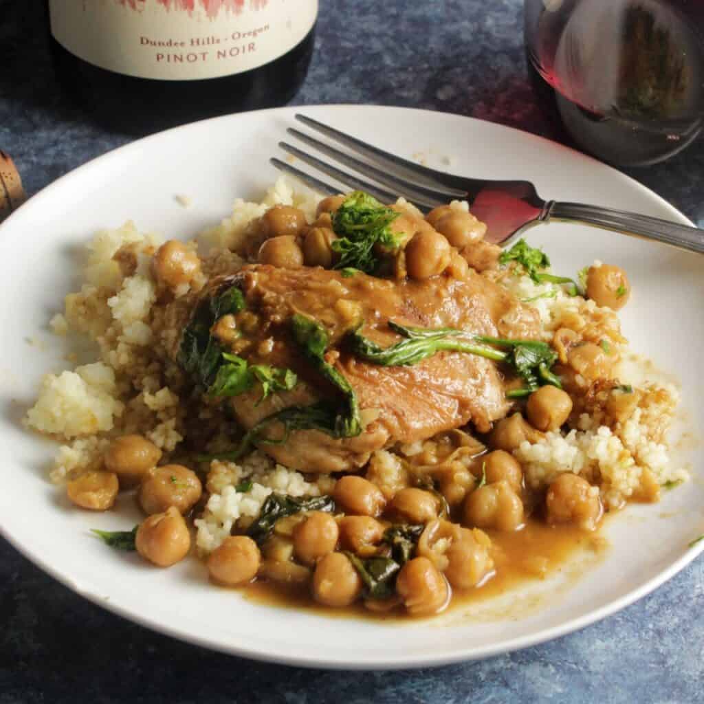 braised Moroccan chicken thighs served over couscous with chickpeas.