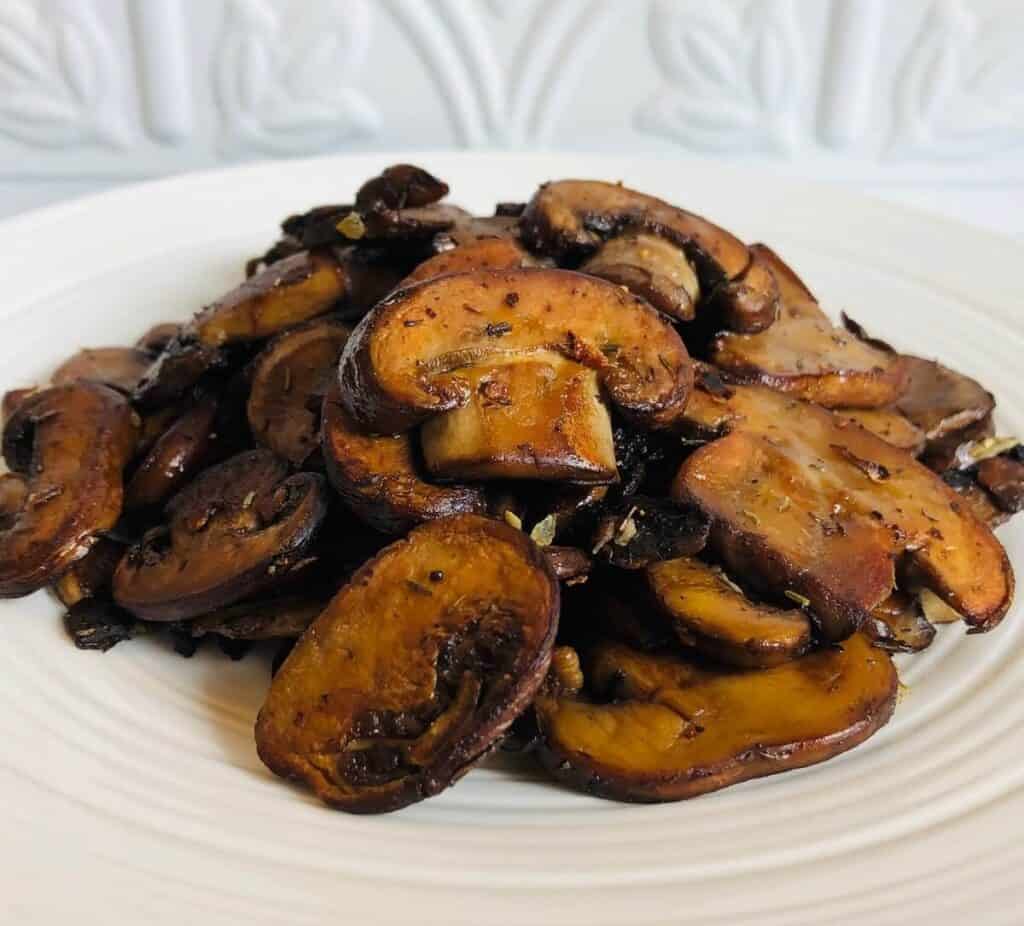 caramelized mushrooms on a white plate. image from A Sweet Alternative.