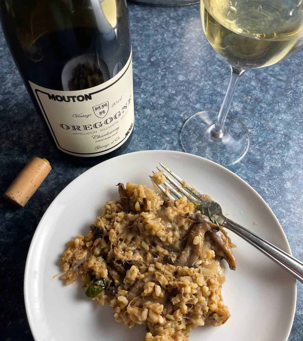 pulled pork risotto on a white plate, served with Oregogne Chardonnay.