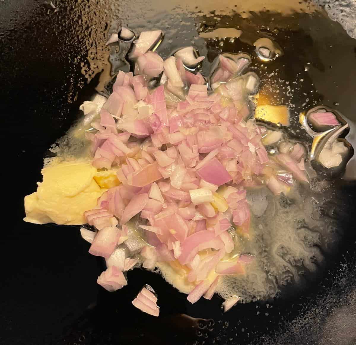 chopped shallot in a black skillet with melted butter. 