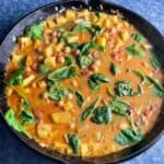 butternut squash and chickpea curry in a large black skillet.