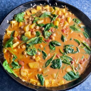 butternut squash and chickpea curry in a large black skillet.