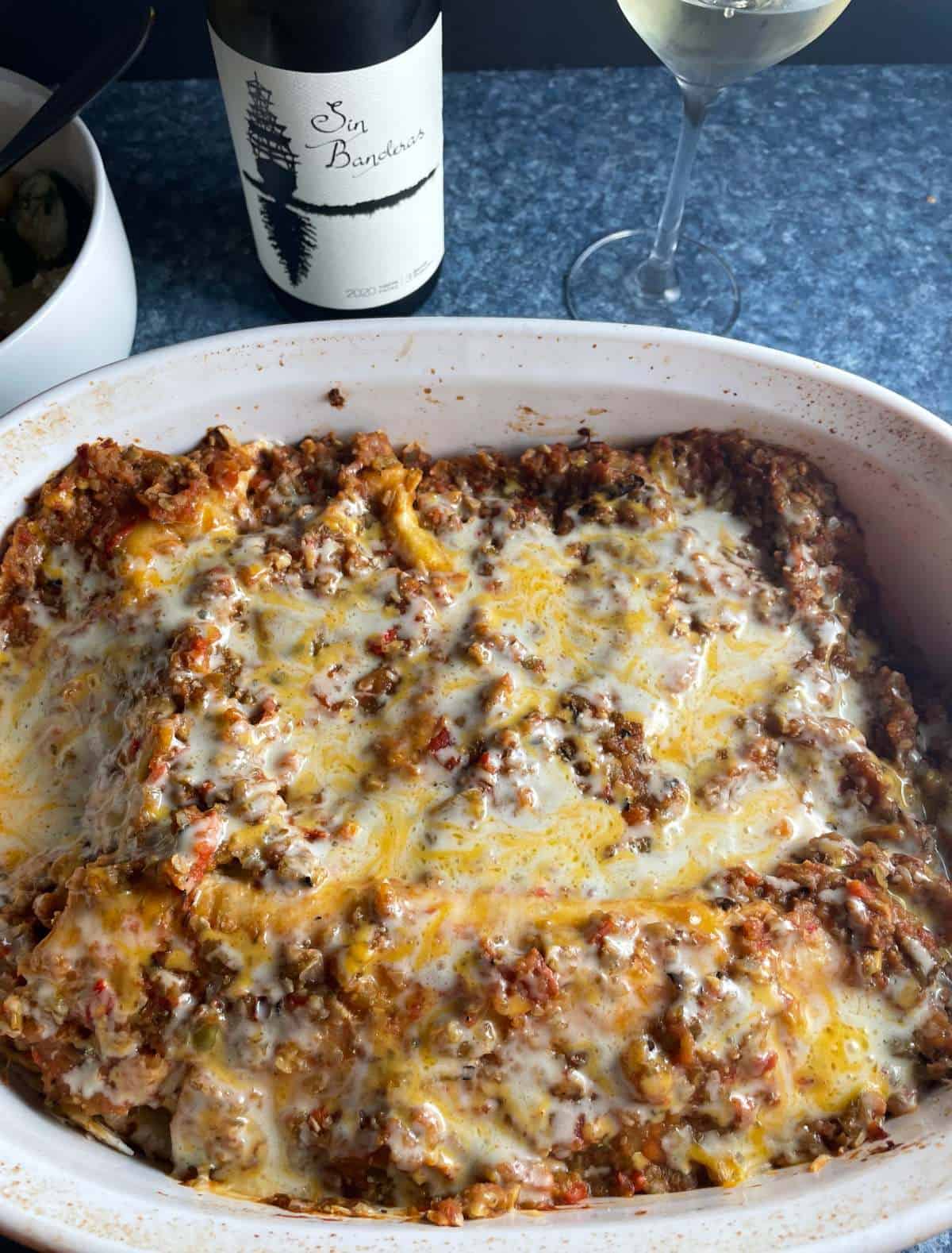 baking dish with veggie enchiladas served with a Riesling wine.